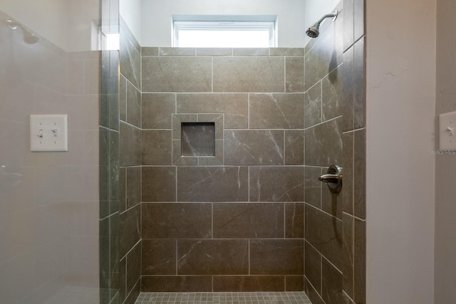 bathroom with a tile shower