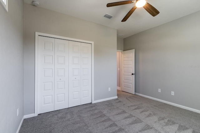 unfurnished bedroom with carpet, visible vents, a closet, and baseboards