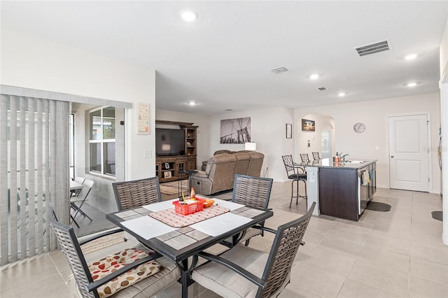 tiled dining room featuring sink