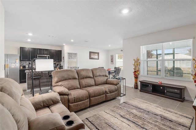 living room with light tile patterned floors and a textured ceiling