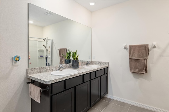 bathroom with tile patterned floors, vanity, and walk in shower