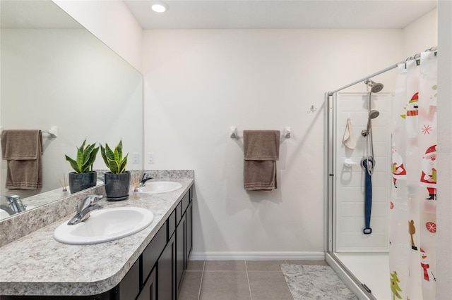 bathroom with tile patterned flooring, vanity, and walk in shower