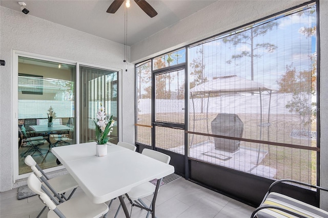 sunroom / solarium featuring ceiling fan