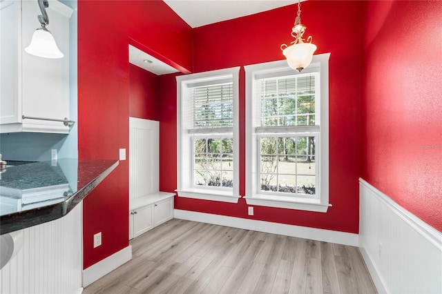 unfurnished dining area with light wood-type flooring