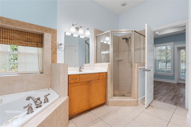 bathroom featuring vanity, plus walk in shower, and tile patterned floors