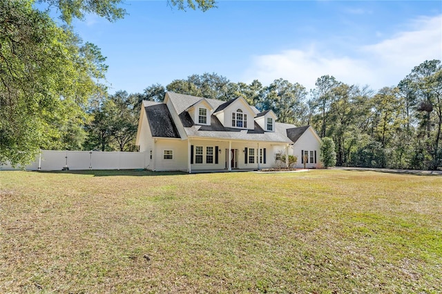 cape cod home with a front lawn