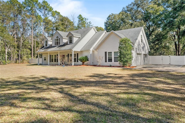 rear view of property featuring a yard and a garage