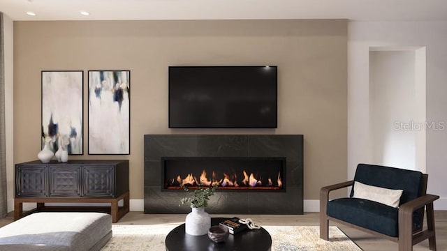 living room with a tile fireplace