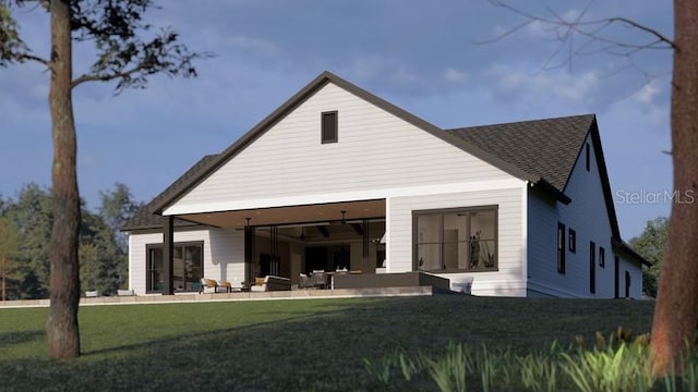 rear view of property with a lawn and ceiling fan