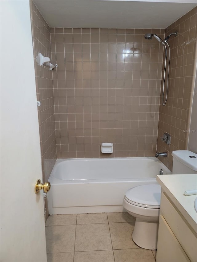 full bathroom with tile patterned floors, vanity, toilet, and tiled shower / bath combo