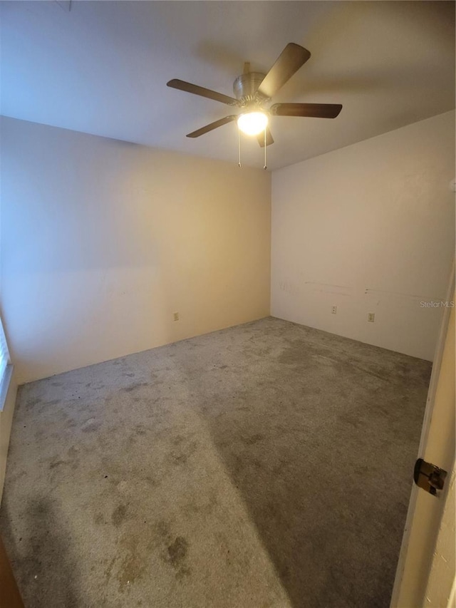 unfurnished room featuring ceiling fan and carpet floors