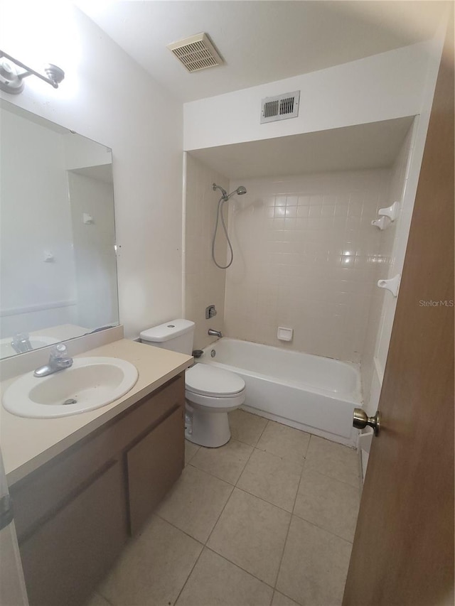 full bathroom featuring tile patterned flooring, vanity, toilet, and tiled shower / bath