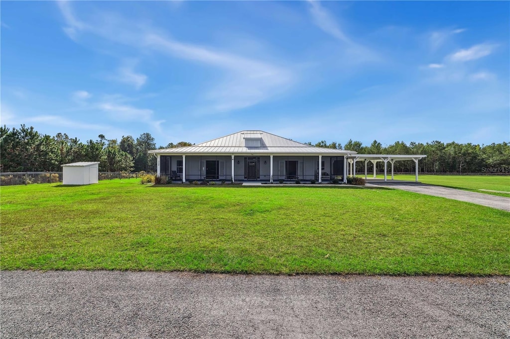 712 SW Rasberry Ct, Fort White, FL 32038 - view of front of home with a front yard, a shed, and a carport