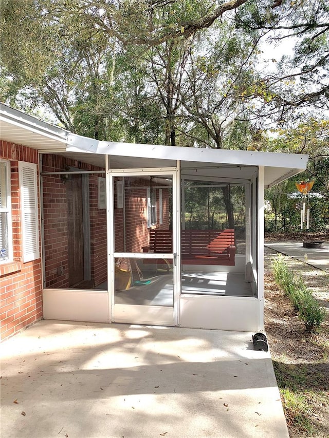 view of patio / terrace featuring a sunroom