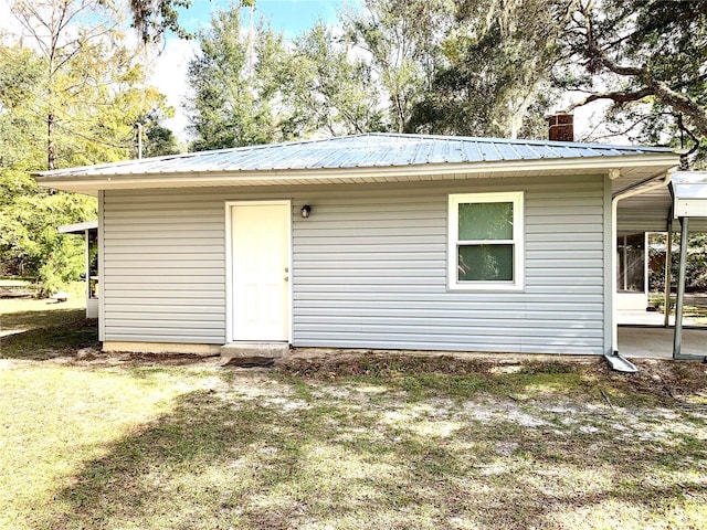 rear view of property with a lawn