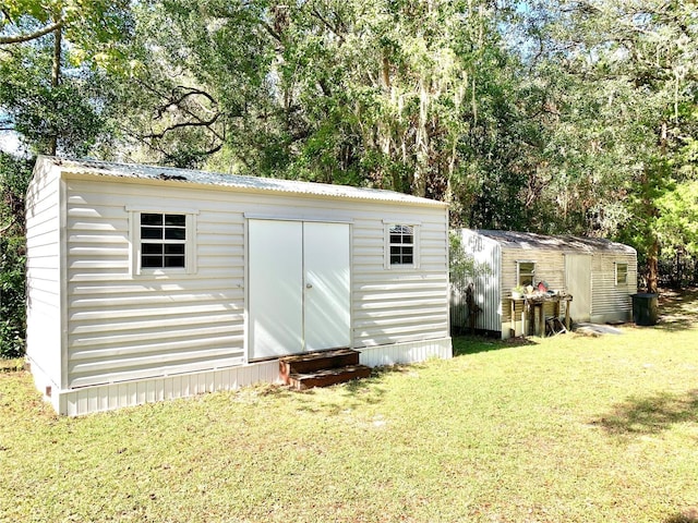 view of outbuilding featuring a lawn