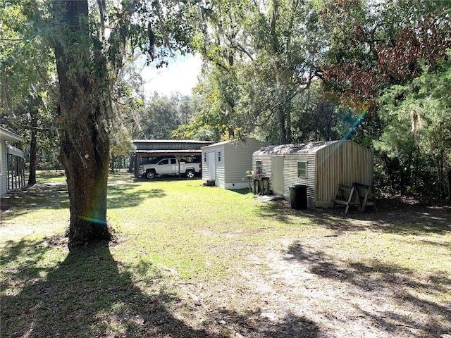 view of yard featuring a shed and a carport