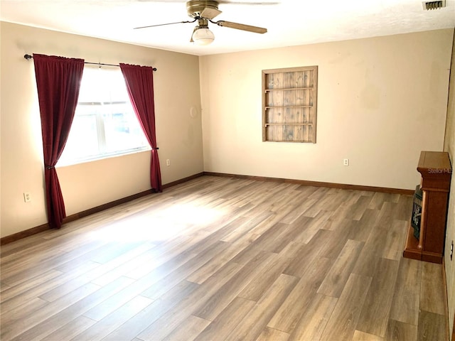 unfurnished room with light wood-type flooring and ceiling fan