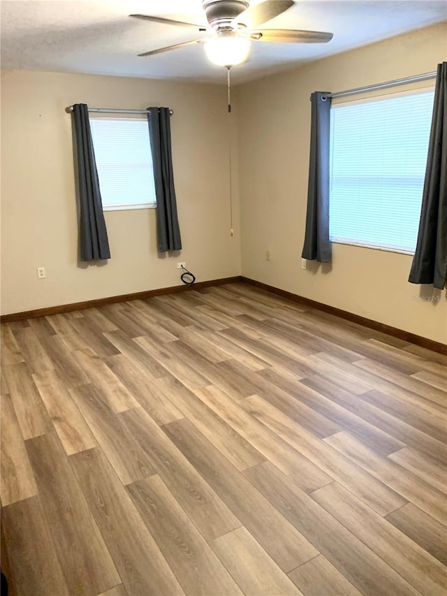 empty room with light hardwood / wood-style floors and ceiling fan