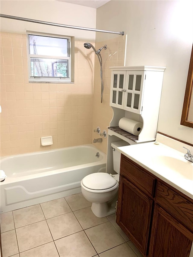 full bathroom featuring tile patterned flooring, vanity, toilet, and tiled shower / bath combo