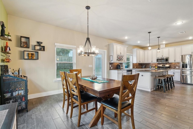 dining space featuring a chandelier and dark hardwood / wood-style floors