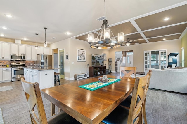 dining space with light wood finished floors, visible vents, coffered ceiling, stairway, and recessed lighting