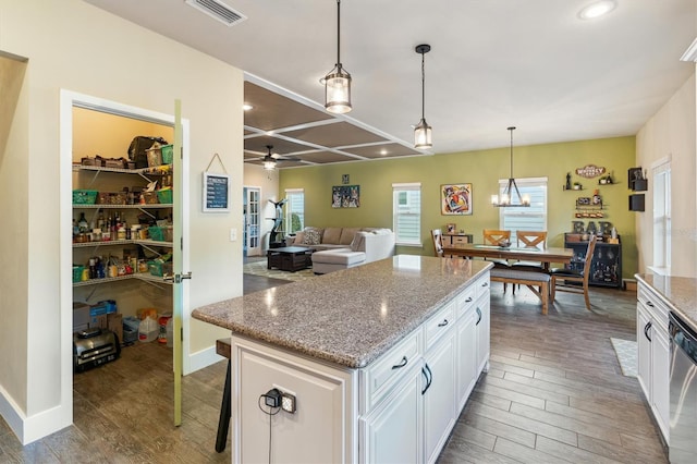 kitchen featuring plenty of natural light, wood finished floors, visible vents, and white cabinets