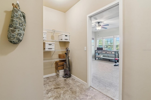 interior space with carpet flooring and baseboards