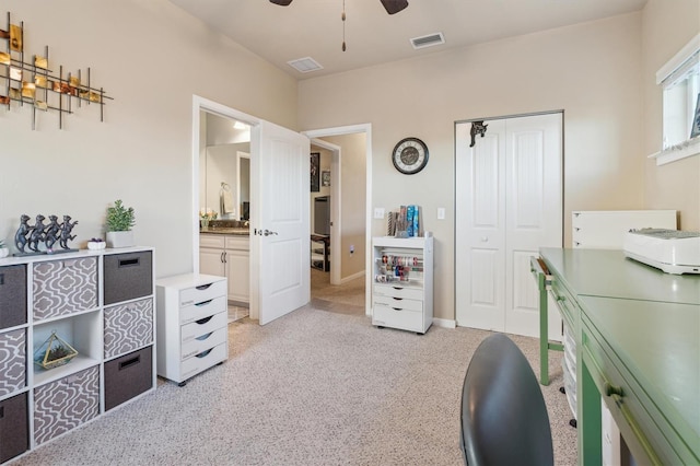 office with baseboards, visible vents, and a ceiling fan