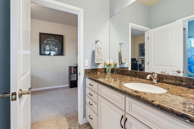 bathroom with vanity and baseboards