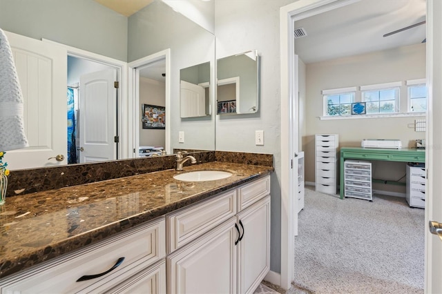 full bath featuring ceiling fan, vanity, visible vents, and baseboards