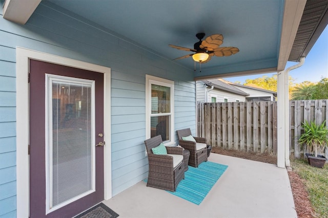 view of patio featuring ceiling fan and fence