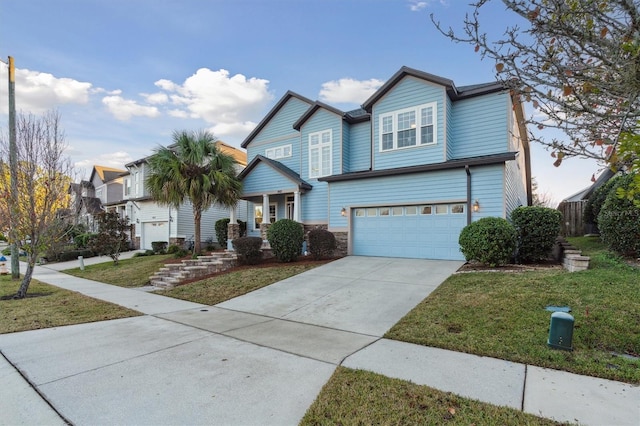 view of front of home with a front lawn, concrete driveway, and an attached garage