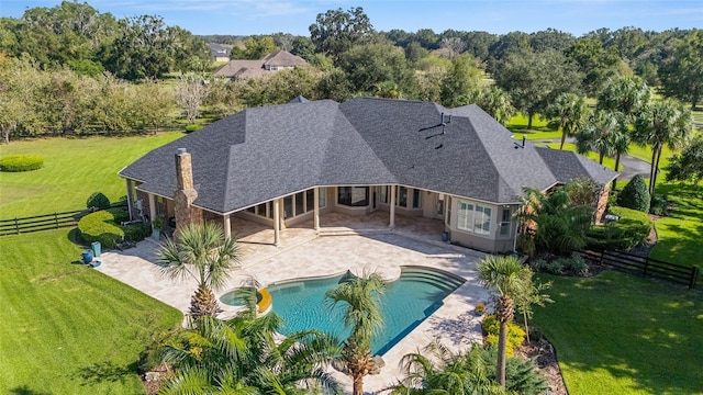 view of pool featuring a yard and a patio