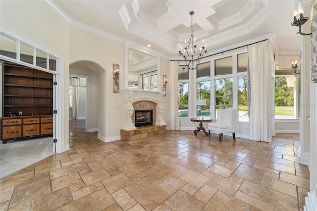 unfurnished room with a tile fireplace, ornamental molding, a high ceiling, and coffered ceiling