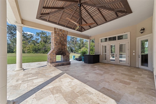 view of patio / terrace featuring an outdoor stone fireplace, french doors, and a gazebo