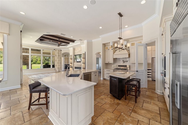 kitchen with a large island, a kitchen breakfast bar, stainless steel appliances, and custom exhaust hood