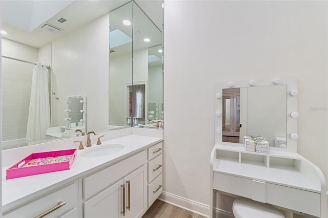 bathroom featuring vanity, curtained shower, toilet, and wood-type flooring