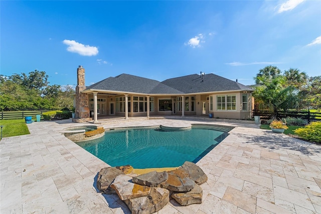 view of swimming pool with a patio area and an in ground hot tub