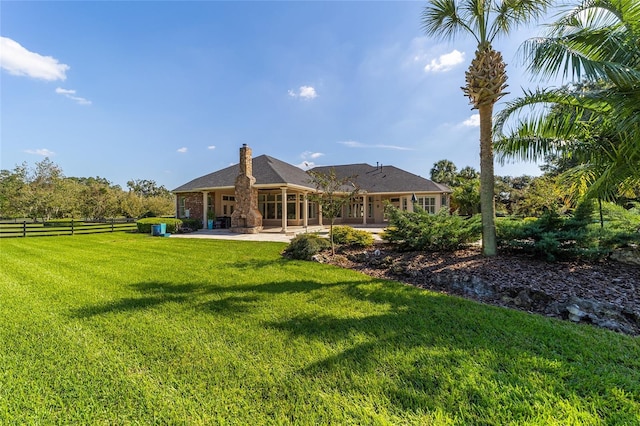 rear view of property with a lawn