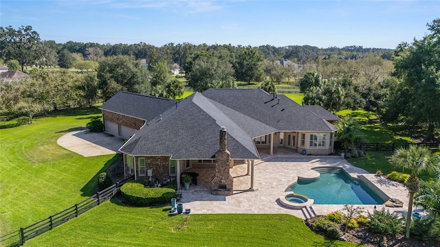 view of swimming pool with a patio area, a yard, and an in ground hot tub