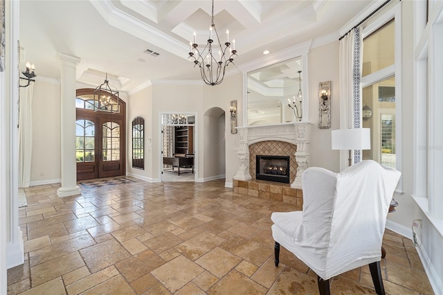 interior space featuring a fireplace, crown molding, a high ceiling, and french doors