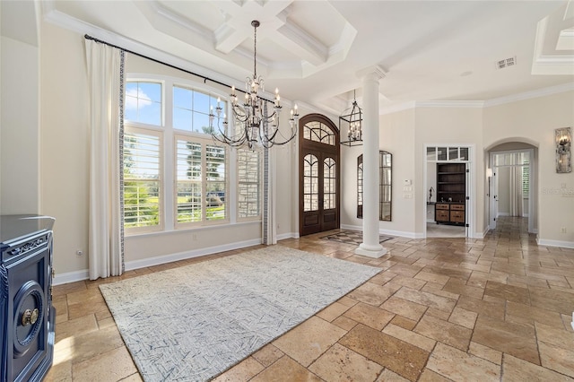 foyer featuring ornate columns, coffered ceiling, a notable chandelier, and ornamental molding