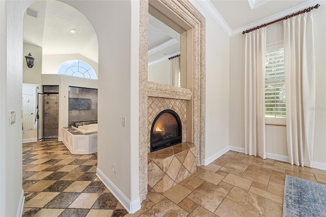 living room with a fireplace and crown molding