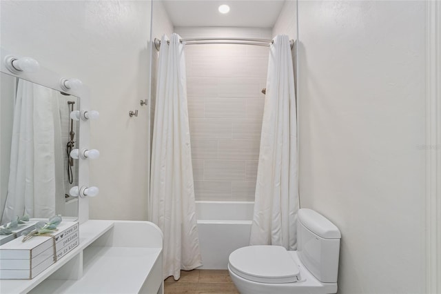 bathroom featuring shower / bathtub combination with curtain, toilet, and wood-type flooring