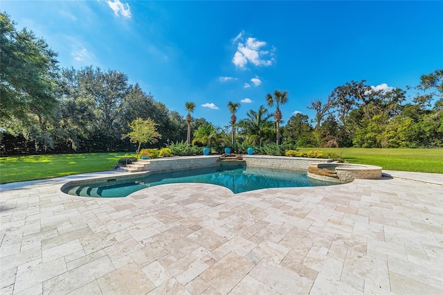 view of swimming pool featuring a lawn, a patio area, and an in ground hot tub