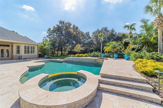 view of swimming pool with a patio area and an in ground hot tub