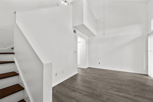 staircase with hardwood / wood-style flooring