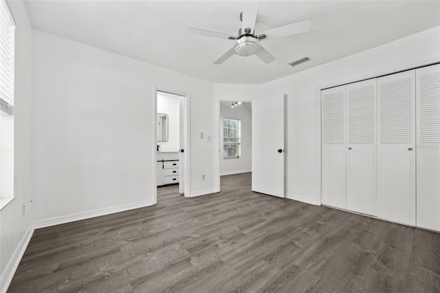 unfurnished bedroom featuring ceiling fan, dark wood-type flooring, and a closet