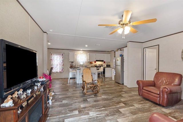 living room featuring ceiling fan and dark wood-type flooring